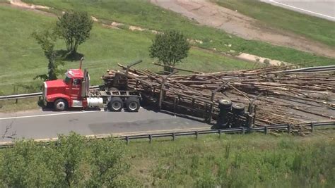 Driver Charged After Logging Truck Flips Spills Load Onto Sc Highway