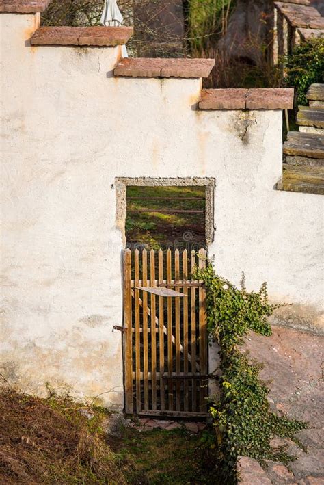 Old Brown Weathered Wooden Door In White Stone Building Stock Photo