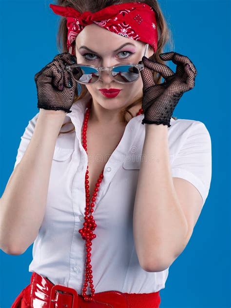 An Attractive Girl With A Red Bandana On Her Head Attentively Looks With Lowered Glasses Girl