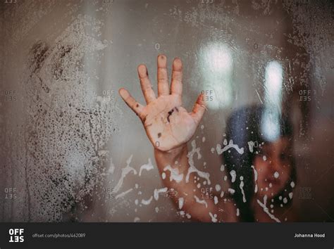 Muddy Hand Of Girl Pressed Up Against Glass Wall Of The Shower Stock Photo OFFSET