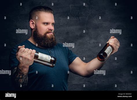 Bearded Male Looking At Two Empty Beer Bottles Stock Photo Alamy