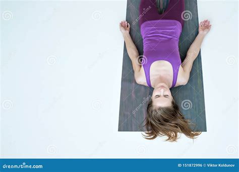 Woman Practicing Yoga Lying In Savasana Exercise Resting After Yoga