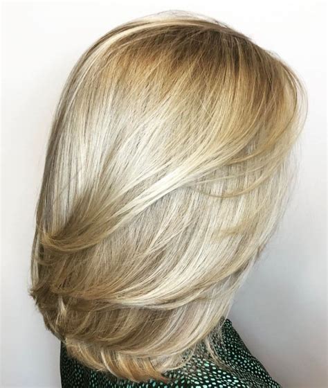 Medium Blonde Hairstyle With Feathered Layers Thick Hair
