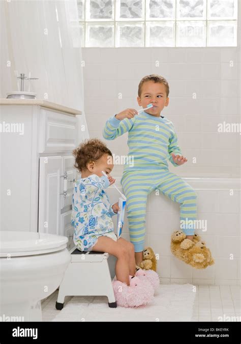 Brother And Sister In Bathroom Brushing Their Teeth Stock Photo Alamy