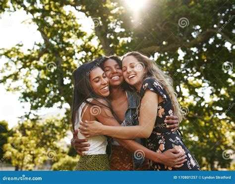 Portrait Of Happy Three Multiethnic Multiracial Female Friends Closely Hugging And Showing Care