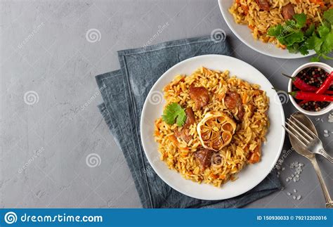 Pilaf From From Rice Vegetables And Meat In A Plate On Gray Background