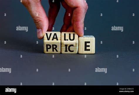 Value And Price Symbol Businessman Turns Wooden Cubes And Changes The