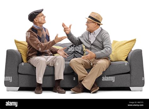 Two Elderly Men Sitting On A Sofa And Arguing Isolated On White
