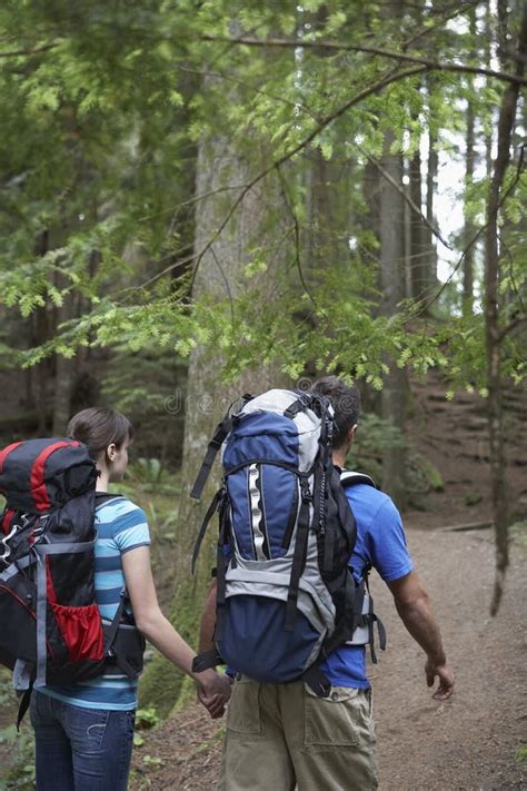 Couple With Backpacks Walking In Forest Stock Image Image Of