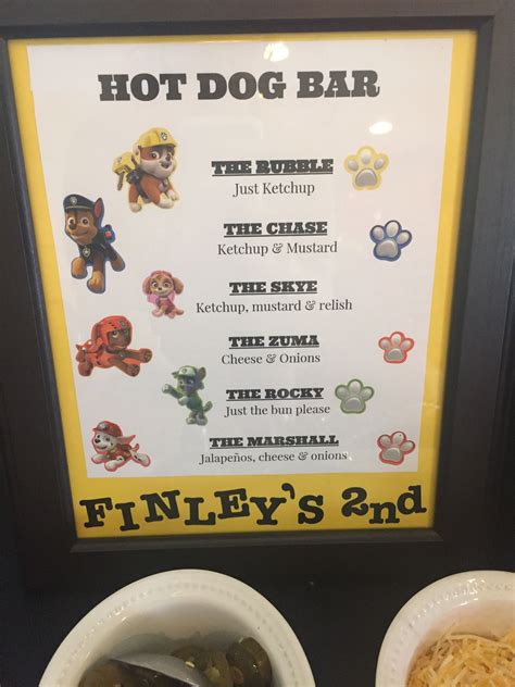 Two White Bowls Filled With Food Next To A Sign That Says Hot Dog Bar