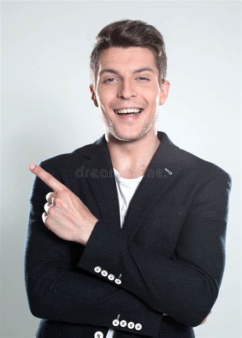 Attractive Young Man In Suit Pointing Up With His Finger Isolate Stock