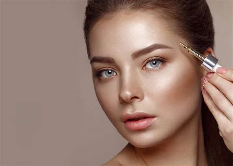 Beautiful Young Girl With Natural Nude Make Up With Cosmetic Tools In Hands Beauty Face