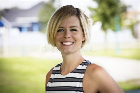 Close Up Of A Happy Blond Woman Smiling Stock Photo Image Of Green