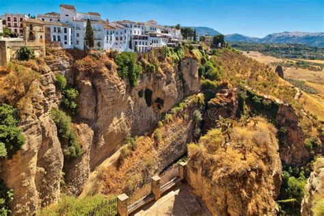 Buildings Standing On The Edge Of A Cliff In Ronda Spain Stock Photo