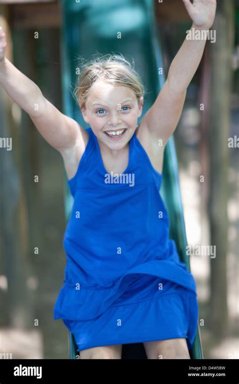 Girl Playing On Slide Outdoors Stock Photo Alamy