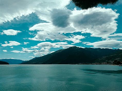 Picturesque View Of Grassy Mountains With Calm Lake At Bottom · Free