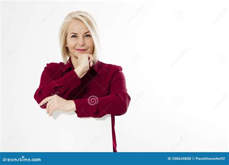 Portrait Of Smiling Cheerful Happy Middle Aged Blonde Woman Sitting On Chair Isolated On White