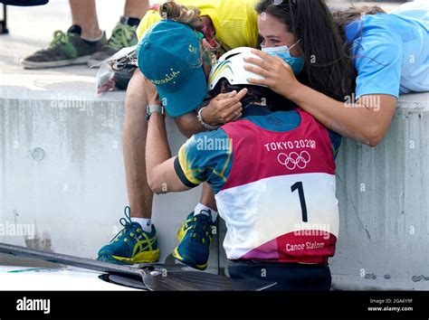 australia s jessica fox hugs members of her team after winning the gold