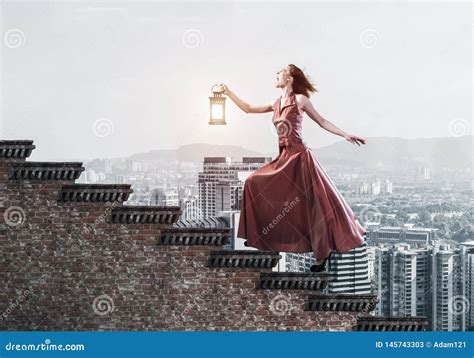 Girl In Long Dress Going Up The Stairway Mixed Media Stock Image