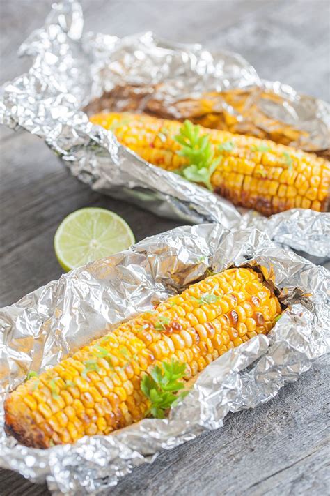 In a small bowl combine garlic butter. Corn on the cob roasted in the oven - ohmydish.com