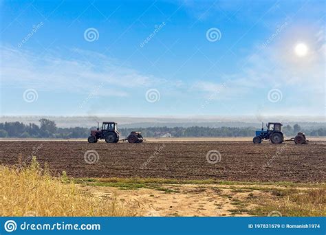 Beautiful Agricultural Landscape with Two Old Tractors Equipped with