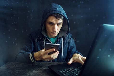 Male Hacker Uses The Mobile Phone To Hack The System Concept Of Cyber