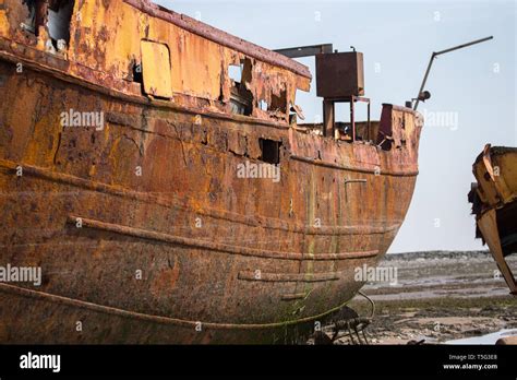 A Ship Wrecked Fishing Boat Aground And Abandoned Rusting Away On The