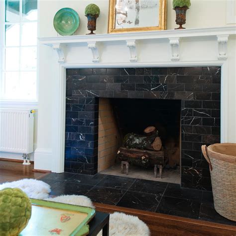 A Living Room With A Fire Place And Pictures On The Fireplace Mantel