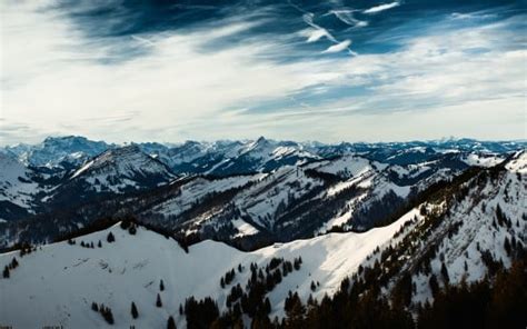 Mountains Green Trees With Snow Slope Under White Clouds Blue Sky 4k Hd