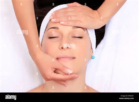 A Young Woman Relaxing At A Health Spa While Having A Facial Treatment