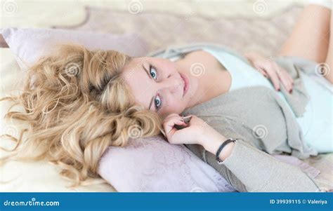Blonde Lying On Bed And Phoning In Bright Bedro Stock Image Image Of