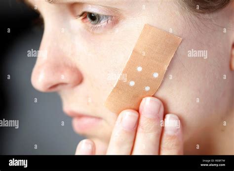 Woman With An Adhesive Bandage On Her Face Stock Photo Alamy