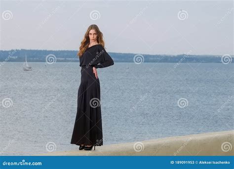 Attractive Fashion Model In Long Dress Posing On The Pier Stock Image