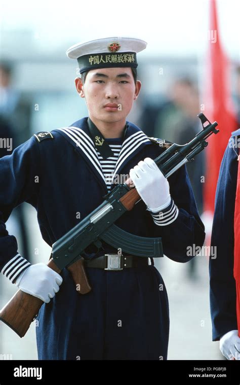 A Chinese Sailor Armed With A Type 56 Assault Rifle Stands Watch