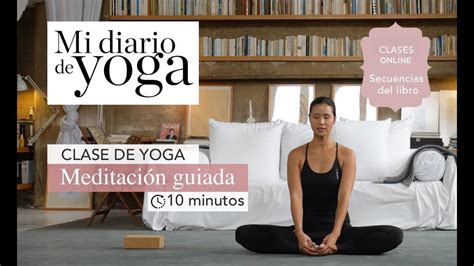 A Woman Is Sitting On The Floor In Front Of A Book Shelf And Doing Yoga