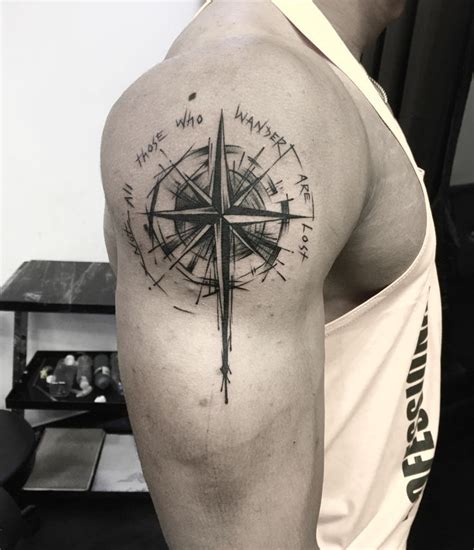 A Man With A Compass Tattoo On His Arm