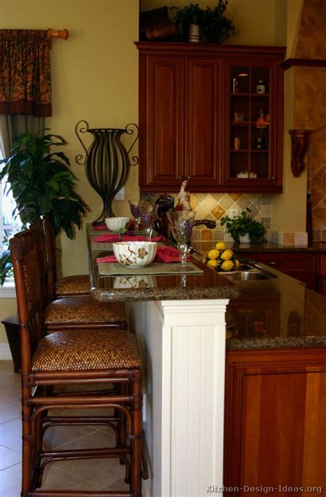A tuscan kitchen showcases the beautiful features of an italian design with rich cabinetry, warm colors and plenty of natural stone materials. Tuscan Kitchen Design - Style & Decor Ideas