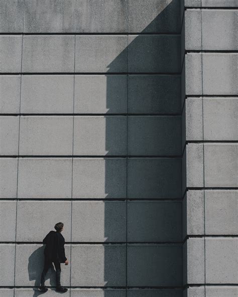 Photo Of Man Standing On Concrete Building · Free Stock Photo