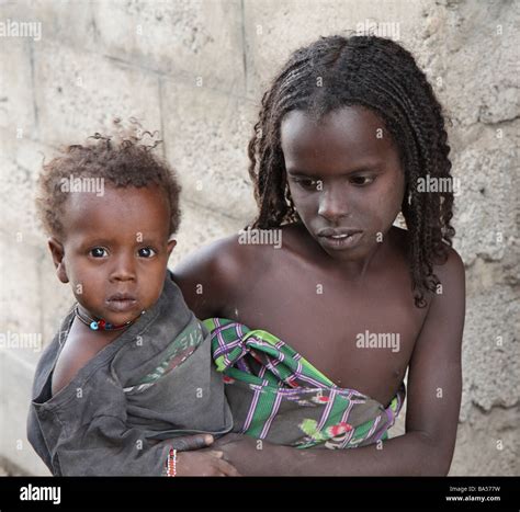 Poverty Stricken Children In Front Of Concrete Building Stock Photo Alamy