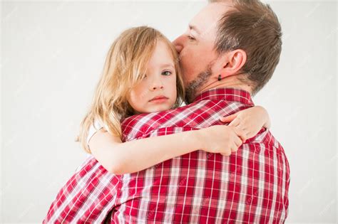 Premium Photo Little Sad Girl On Dads Arms Daughter Hugs Dad