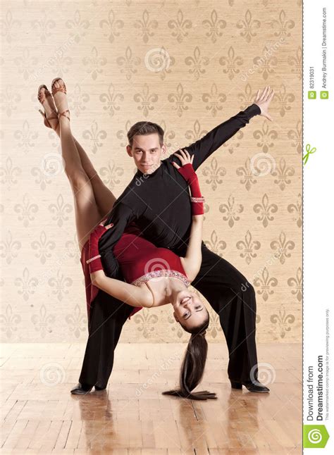 Beautiful Couple In The Active Ballroom Dance On Wall Stock Image