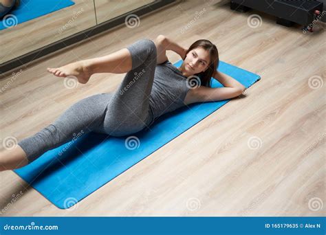 sporty woman stretching while lying on back in sportswear in gym stock image image of person