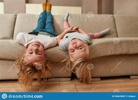 Have Fun Portrait Of Playful Kids Little Boy And Girl Lying Upside