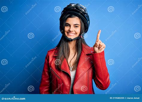 Young Beautiful Brunette Motorcycliste Woman Wearing Motorcycle Helmet And Jacket Showing And