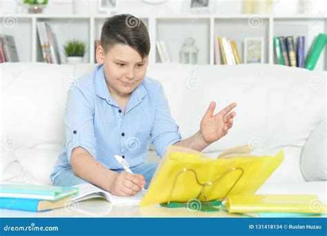 Portrait Of Boy Doing Homework At Home Stock Photo Image Of White
