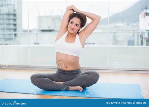 Sporty Content Brunette Stretching On Exercise Mat Stock Photo Image