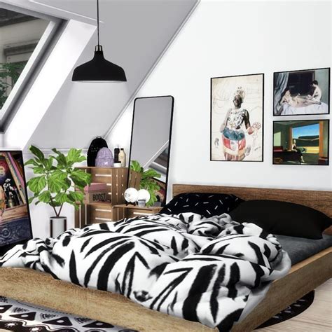 A Bedroom With Zebra Print Bedding And Pictures On The Wall Along With