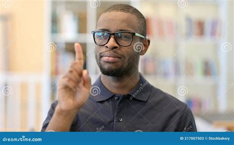 Portrait Of Young African Man Saying No With Finger Sign Stock Image