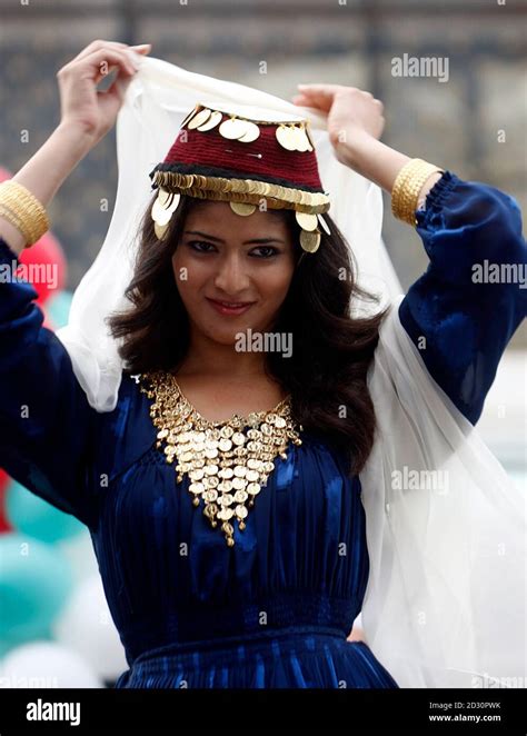 A Model Displays A Traditional Syrian Dress Decorated With Gold During