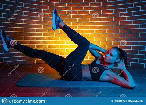 Fit Young Brunette Woman Doind Exercises For Abs On The Fitness Mat In
